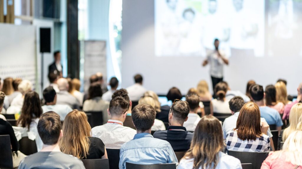 Audience at a conference listening to a speaker