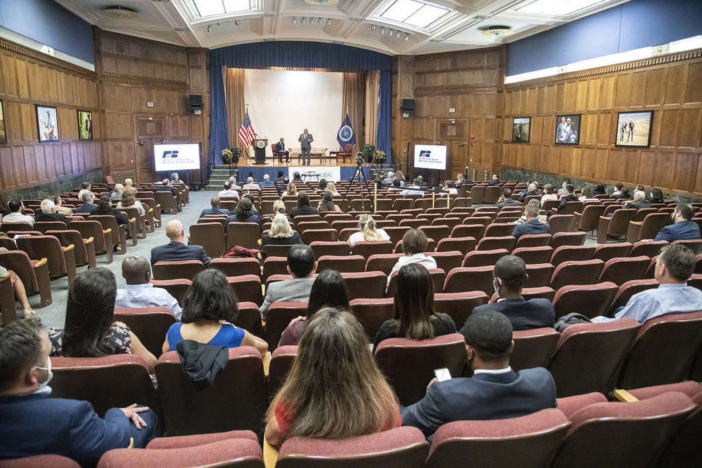 Conference audience in an auditorium watching a speaker
